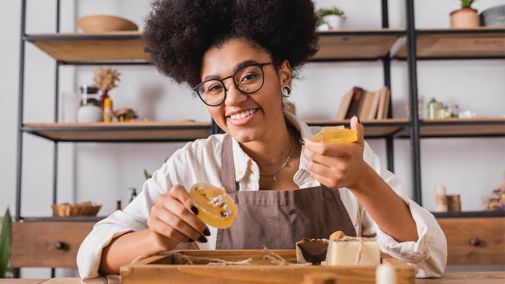 Smiling woman holding up homemade soap