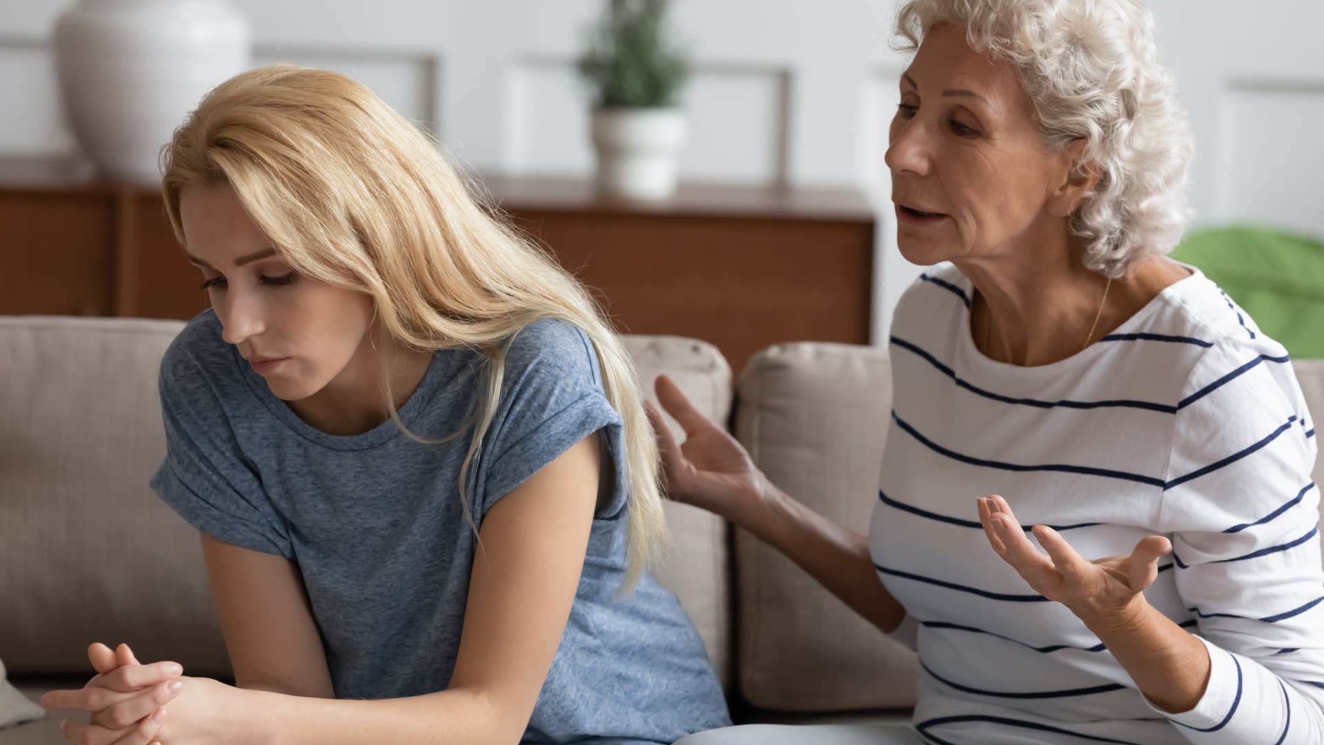 Upset woman turned away from her angry mother.