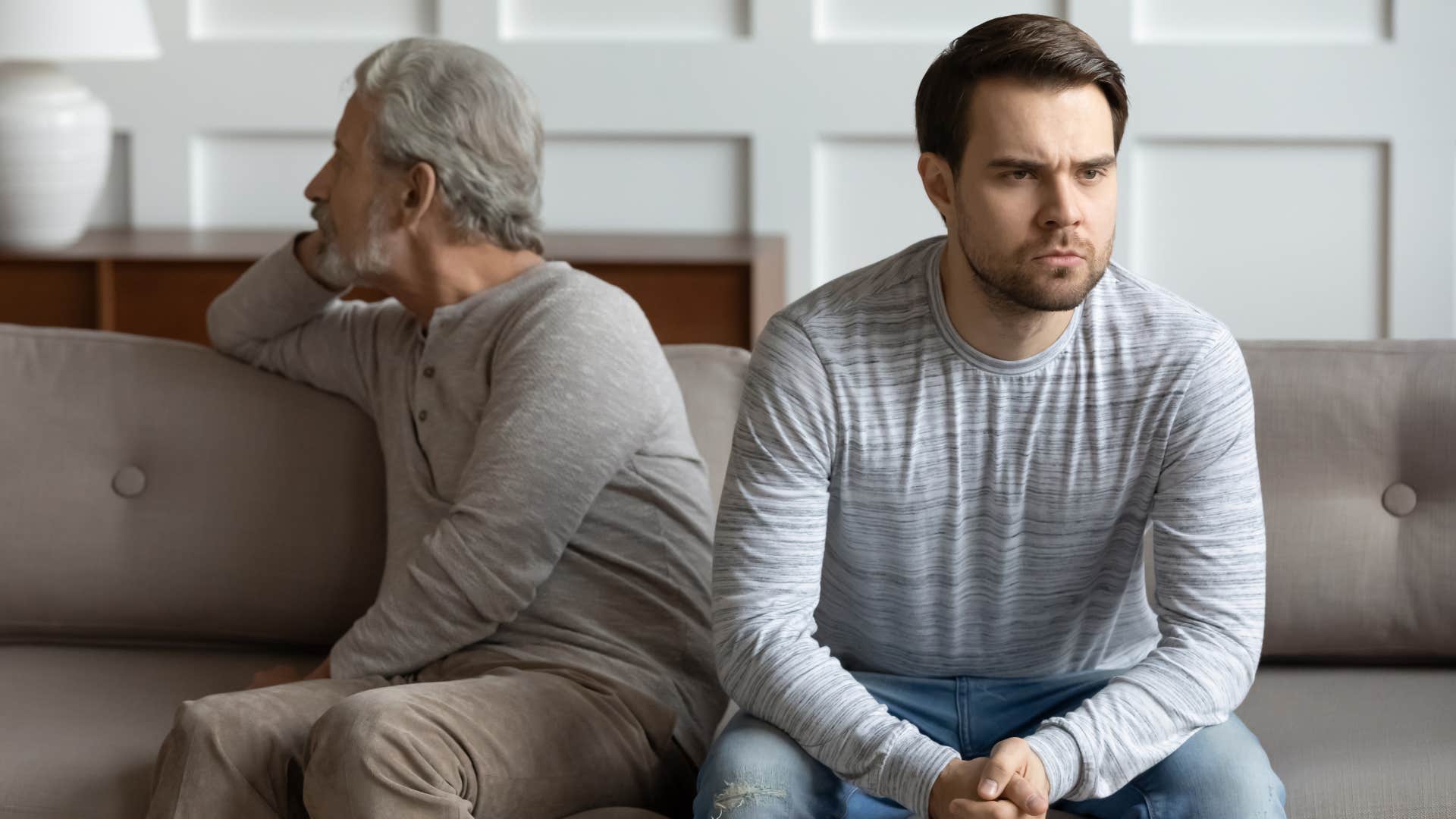 Man turned away from his upset father.