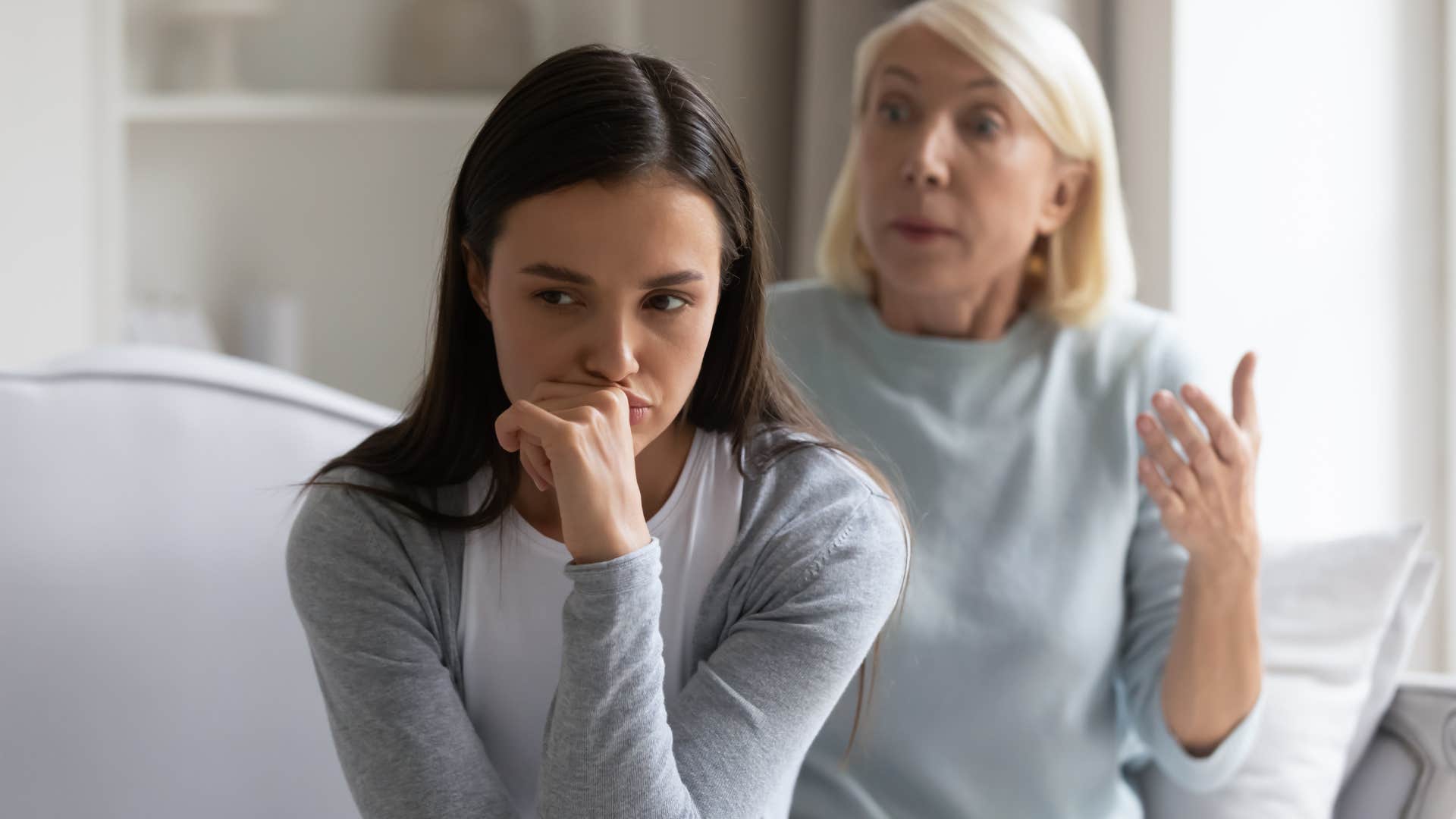 Woman turned away from her upset mother.