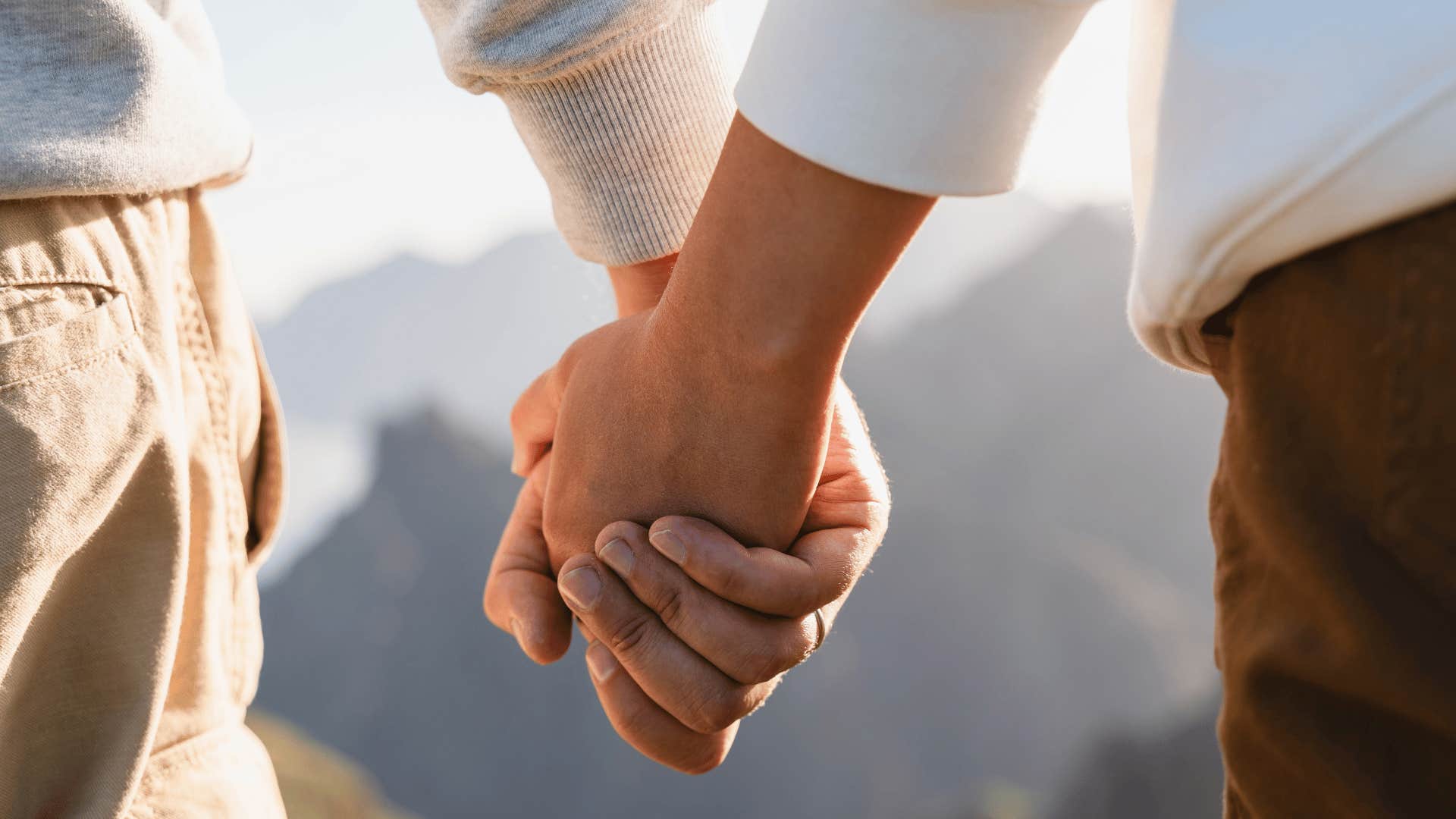 Couple holding hands because love is enough