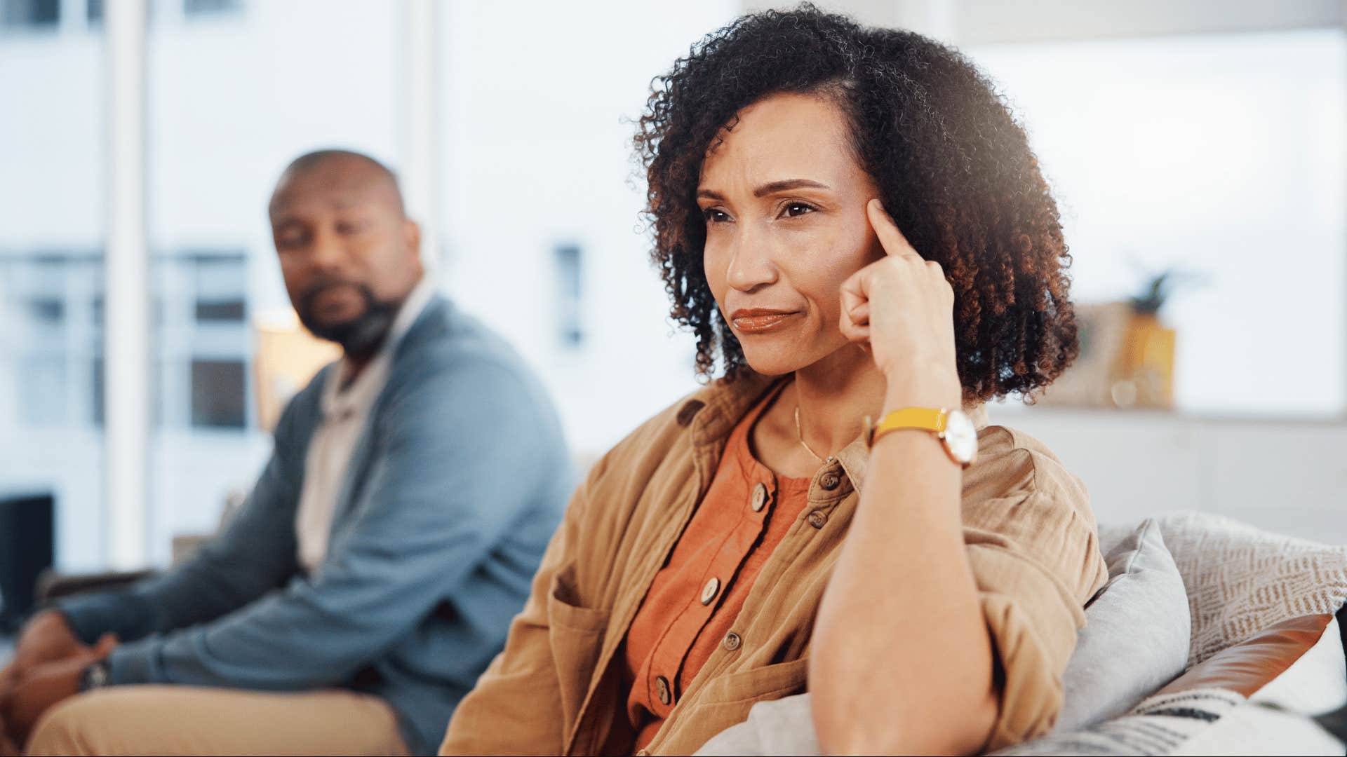 Upset woman thinks while man talks