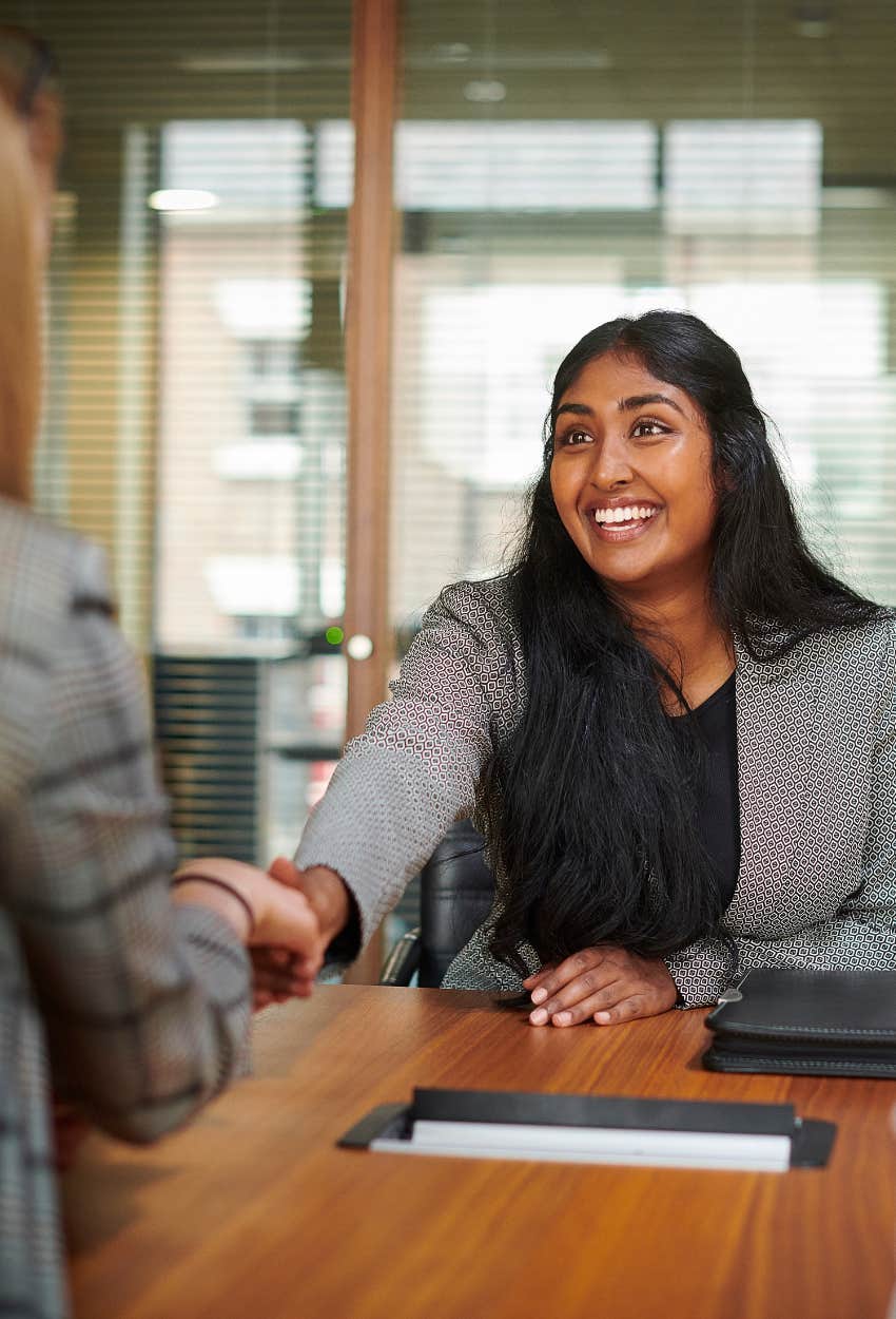 Gen Z job applicant shaking hands with recruiter during interview