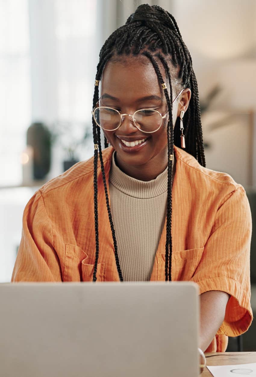 Gen Z woman typing on her computer