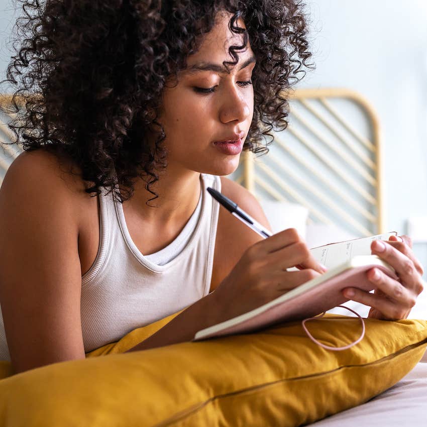 Woman writes a list of steps in her notebook