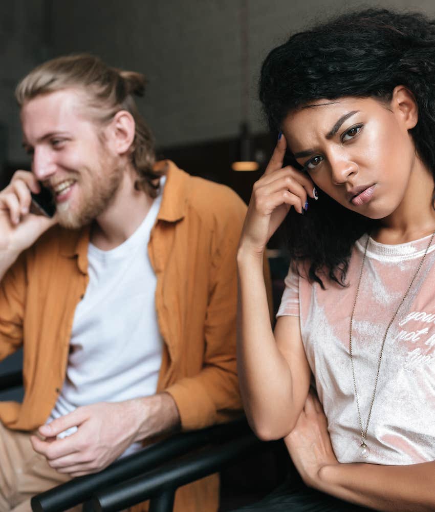 Man talks on phone while woman is annoyed