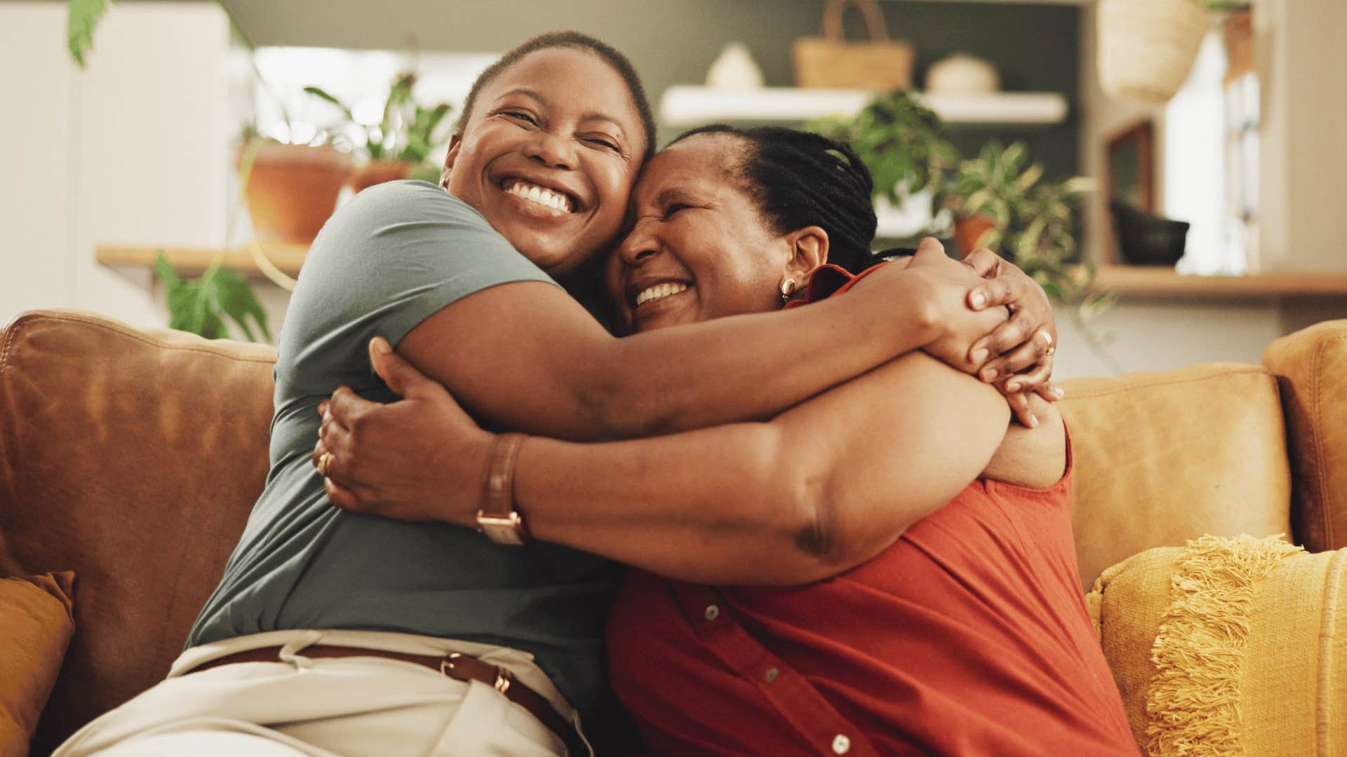 family members hugging on couch