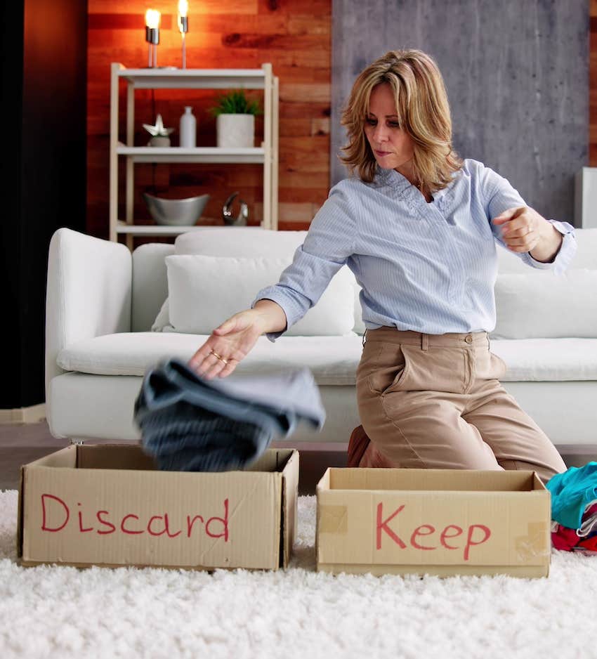 Cleaning woman sorts things to keep and discard