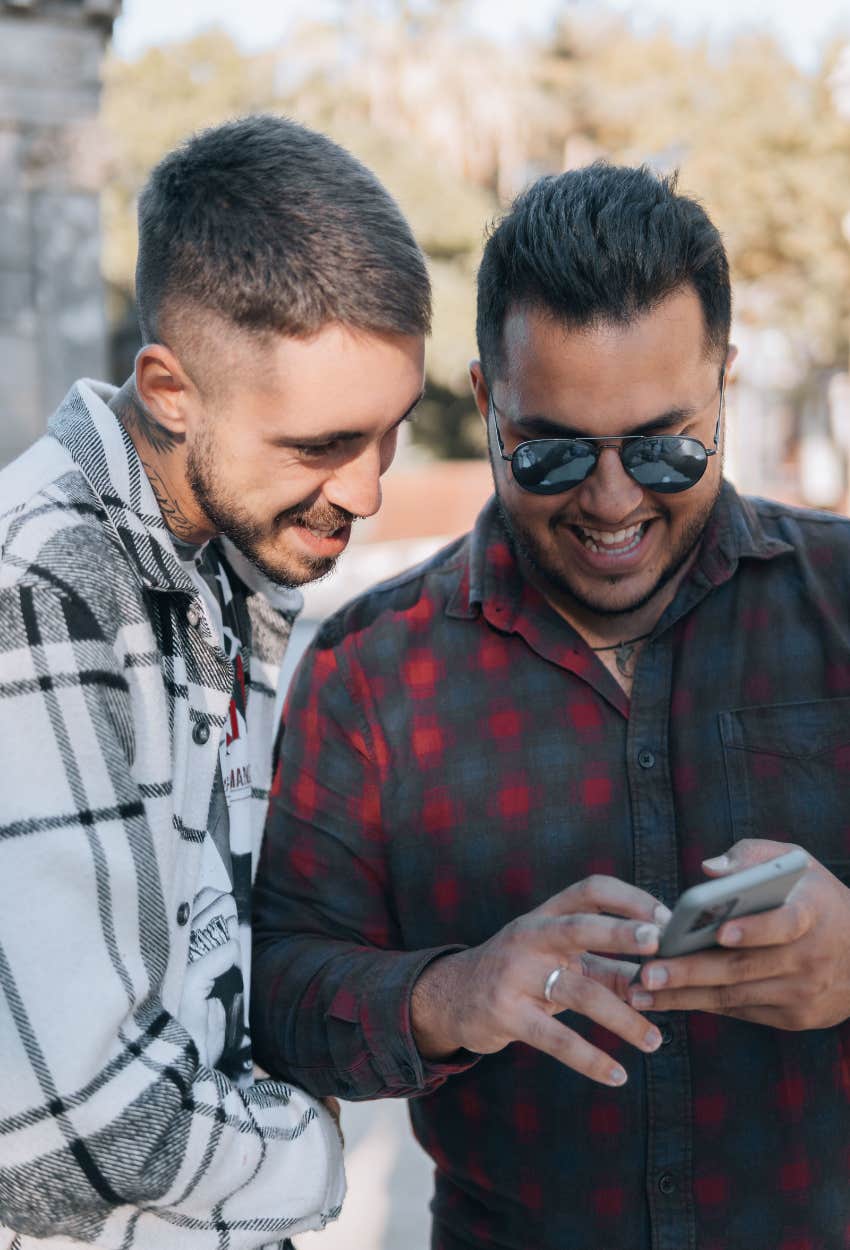 two friends laughing at TikTok video