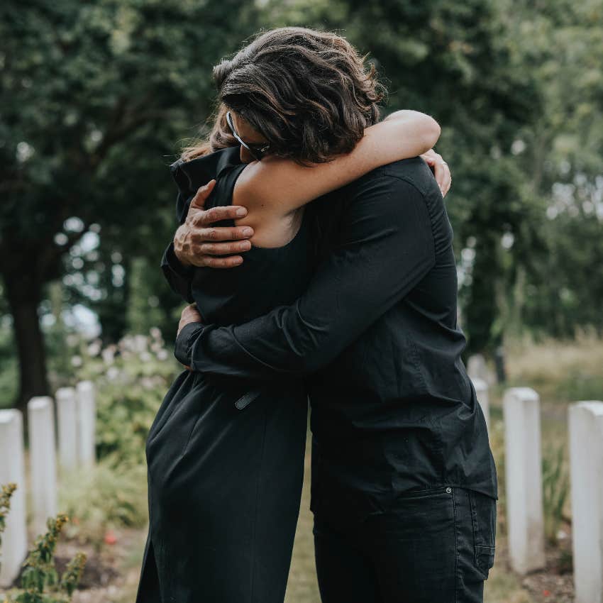 Grieving couple hugging after the death of a loved one