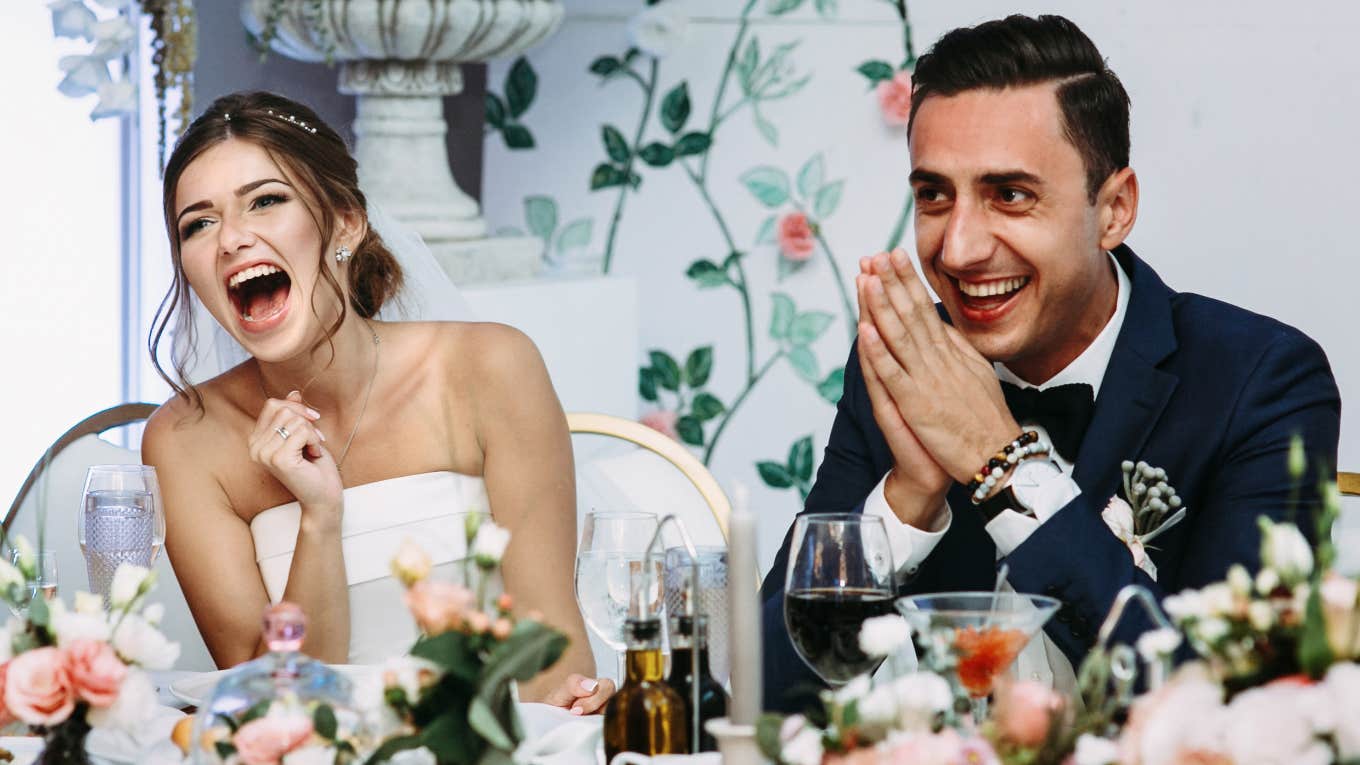 Bride and groom listening to AI best man speech