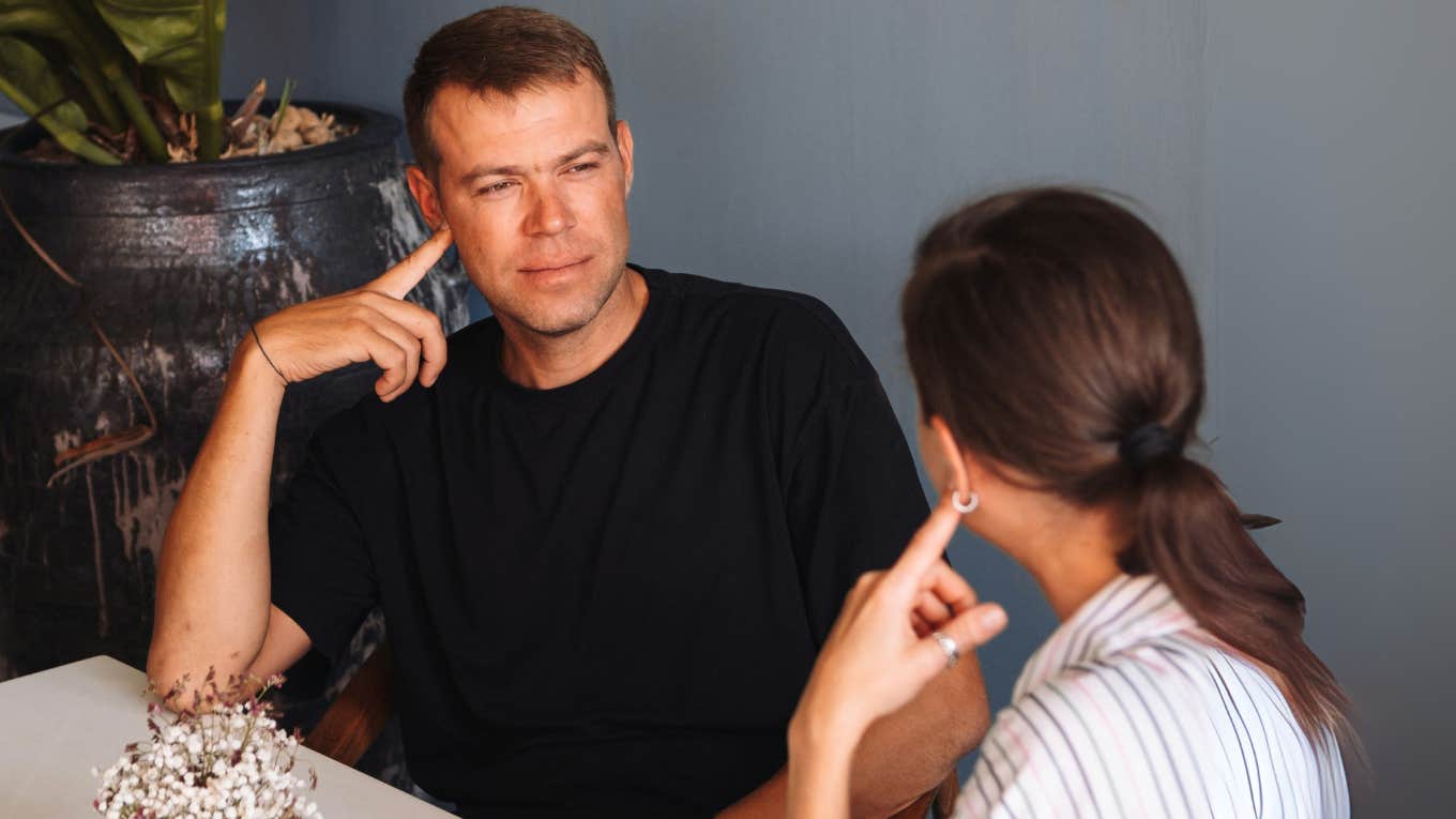 Man being scared away by woman.