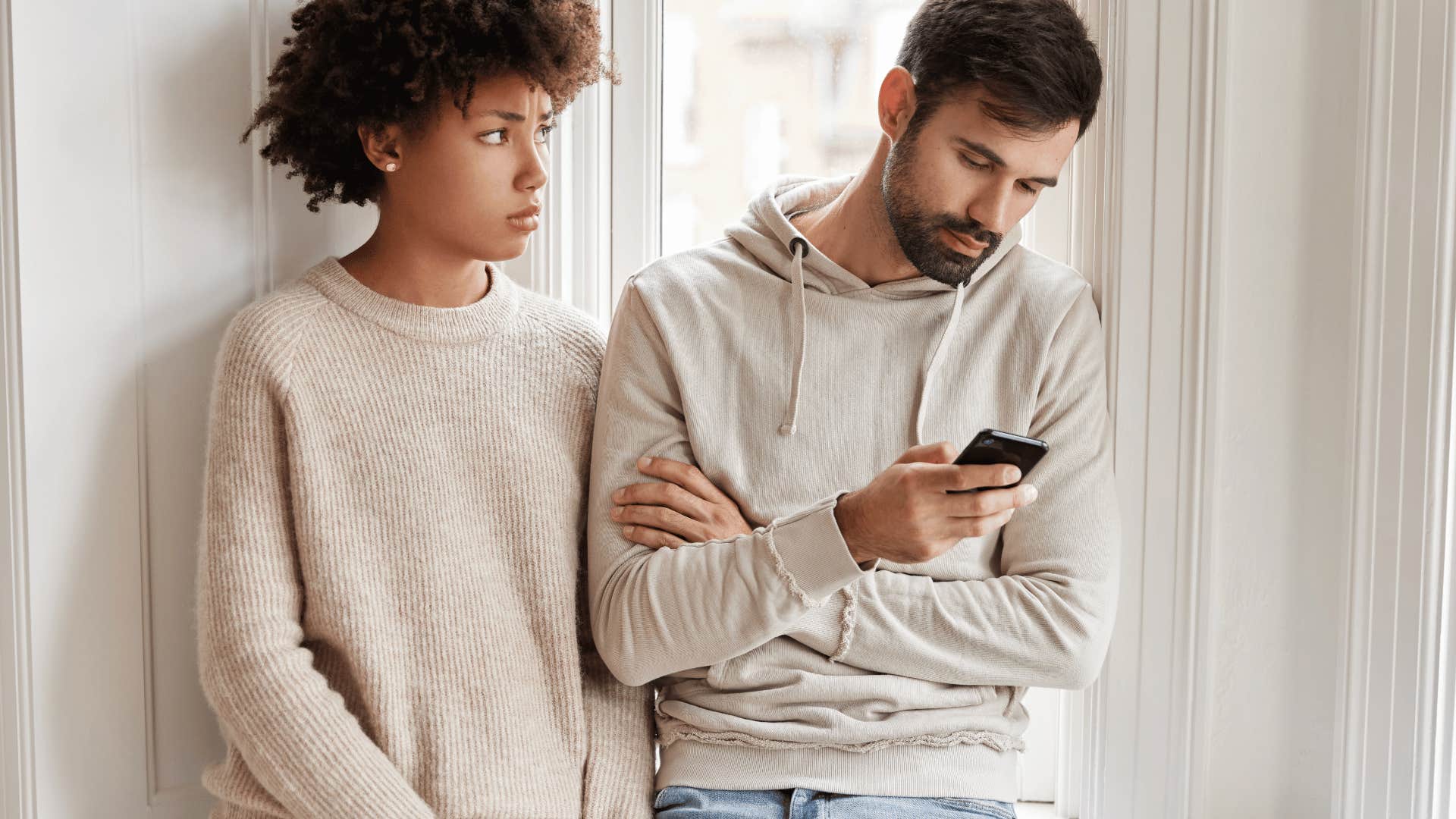 man on phone ignoring woman