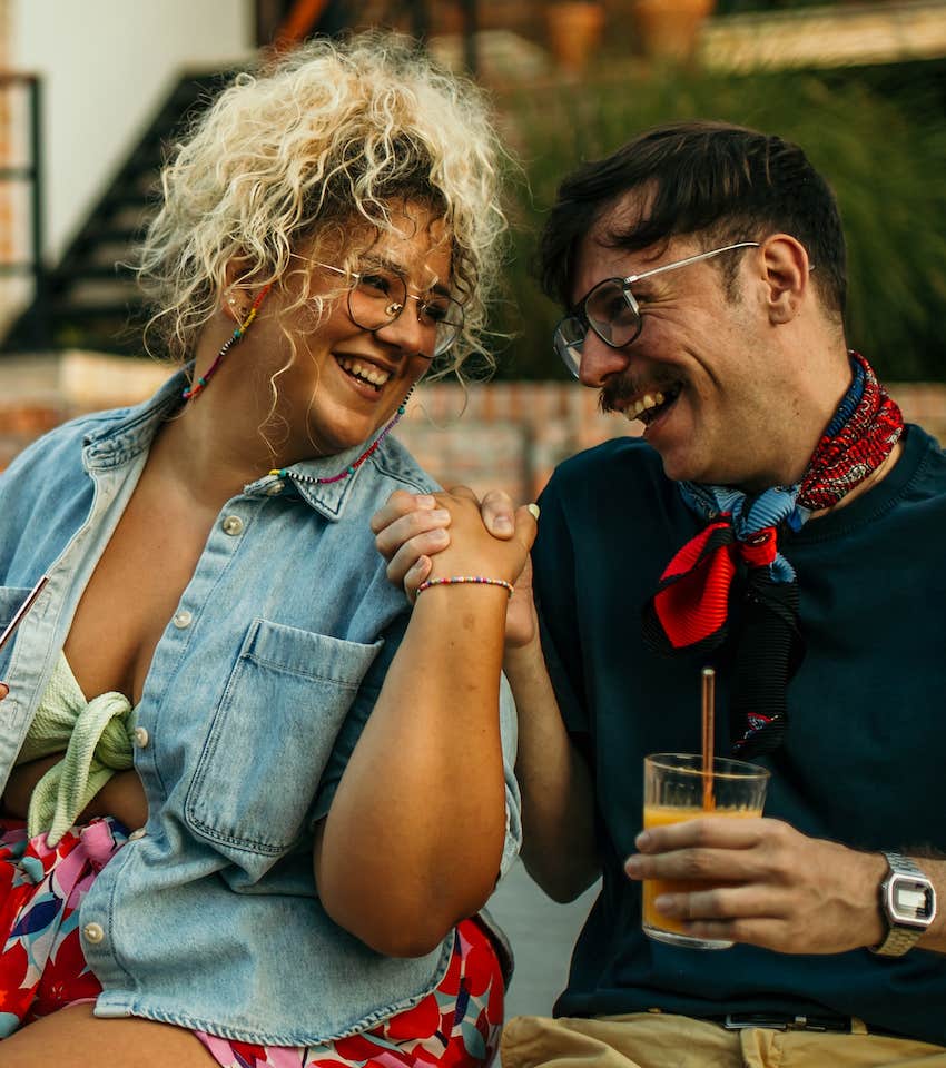 Happy couple holding hands at outdoor cafe