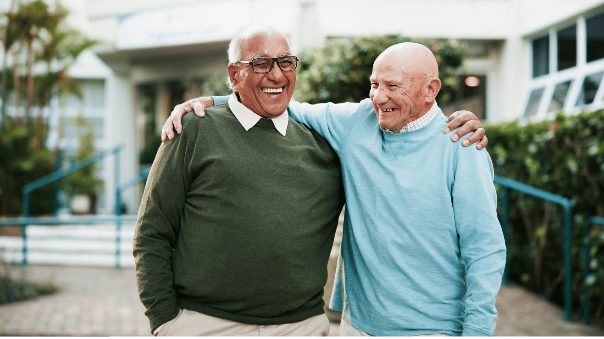 Elderly men embrace to maintain social connection