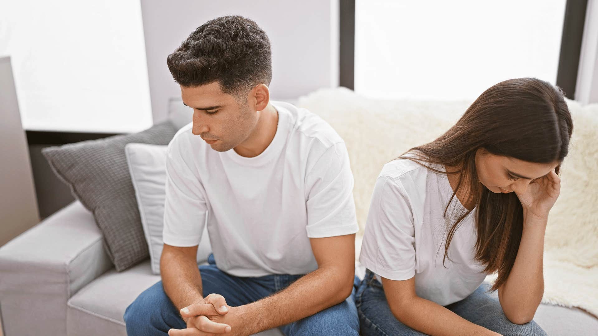 couple not talking to each other on couch