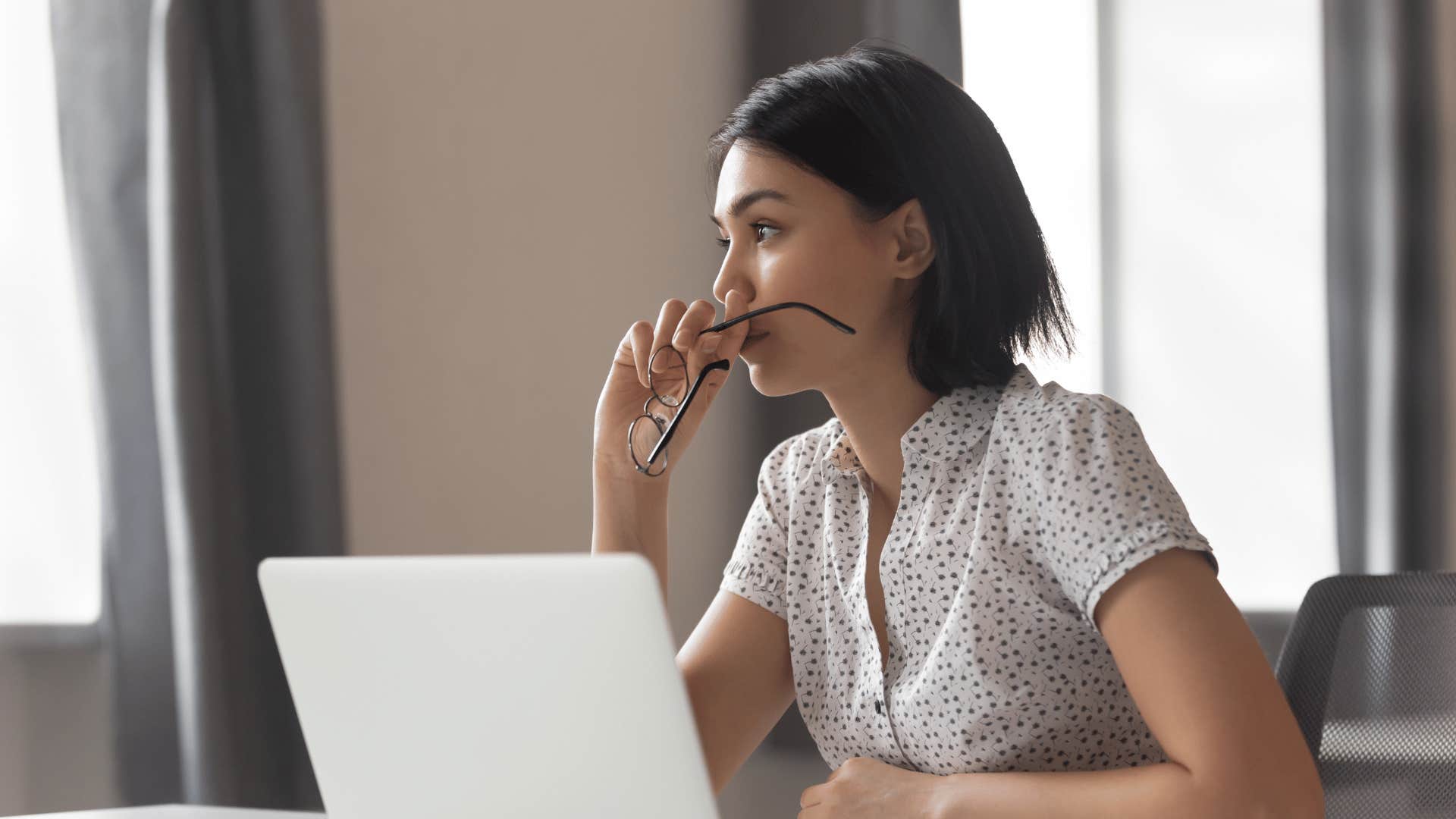 upset woman in front of laptop