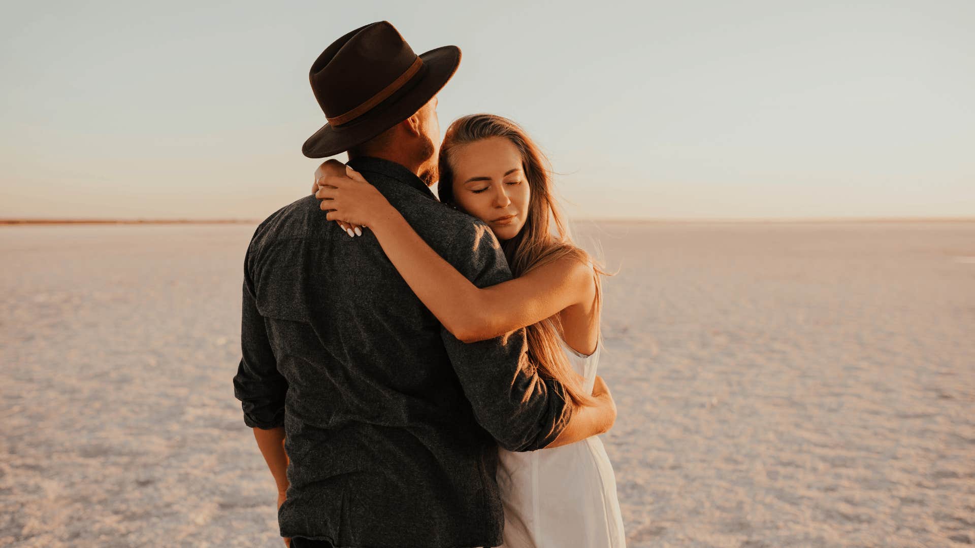 woman hugging her husband in the desert