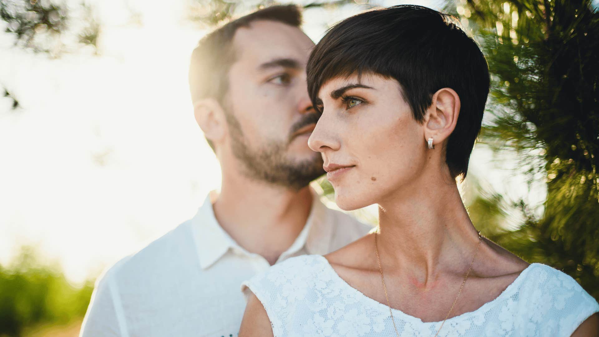 woman and man in white with serious looks on their faces