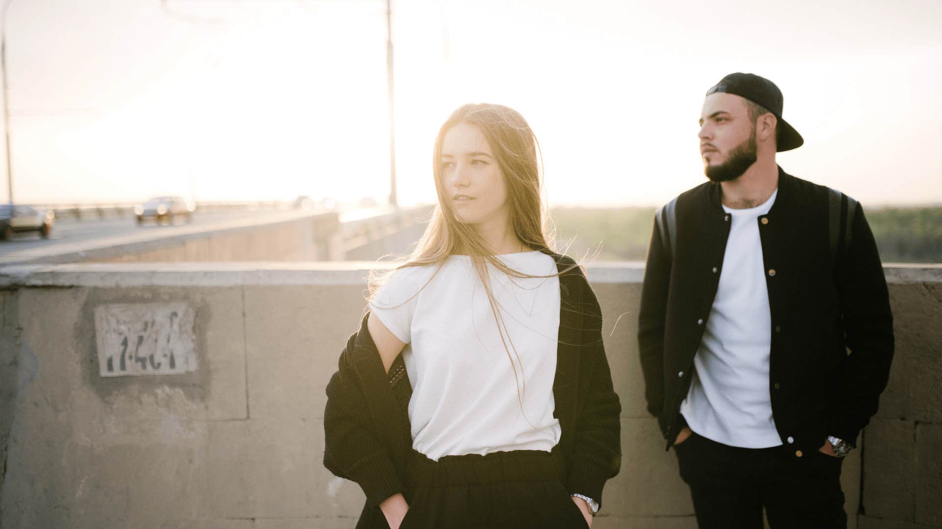 woman and man wearing black and white on the top of a parking garage