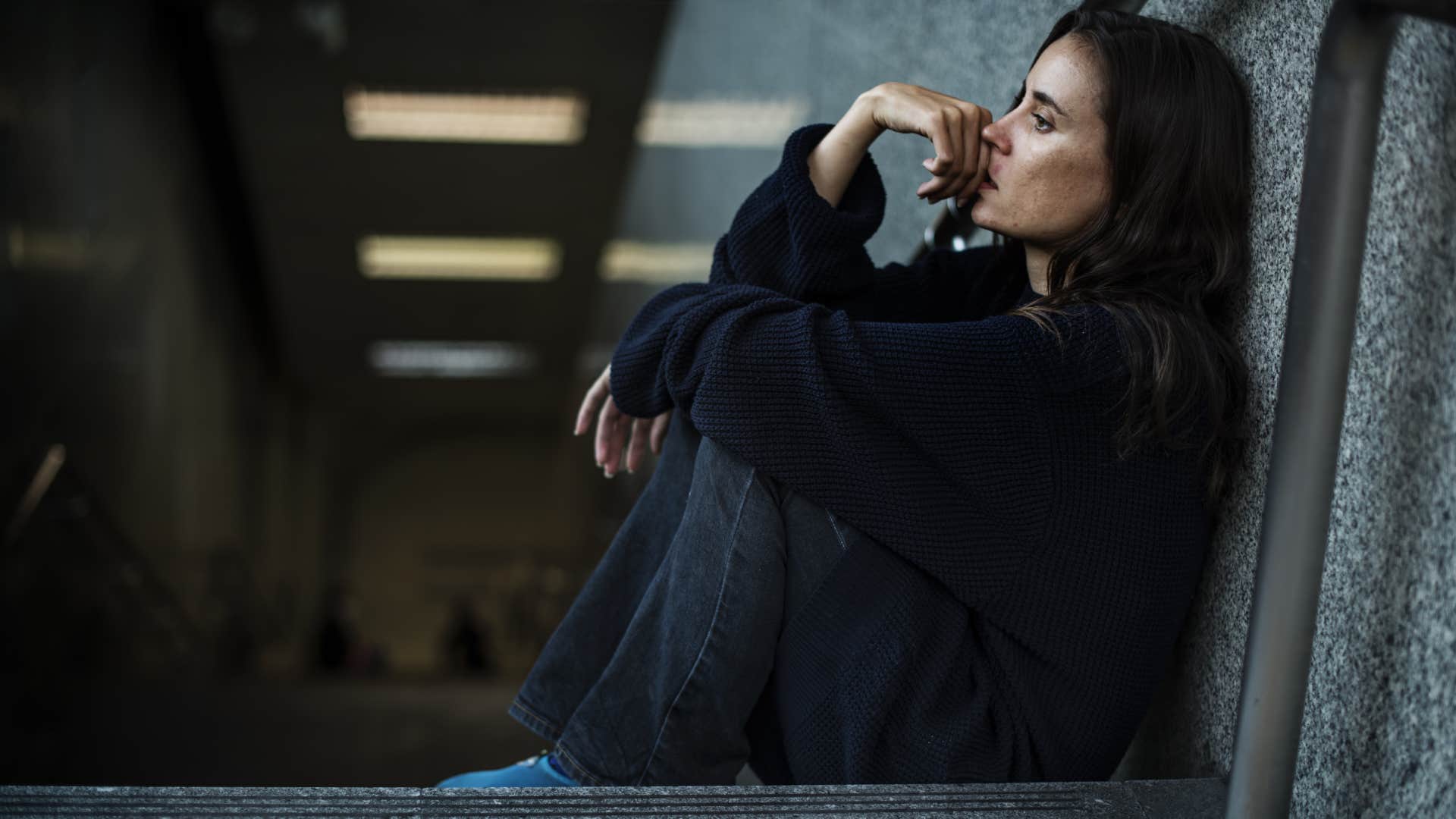 woman sitting looking worried