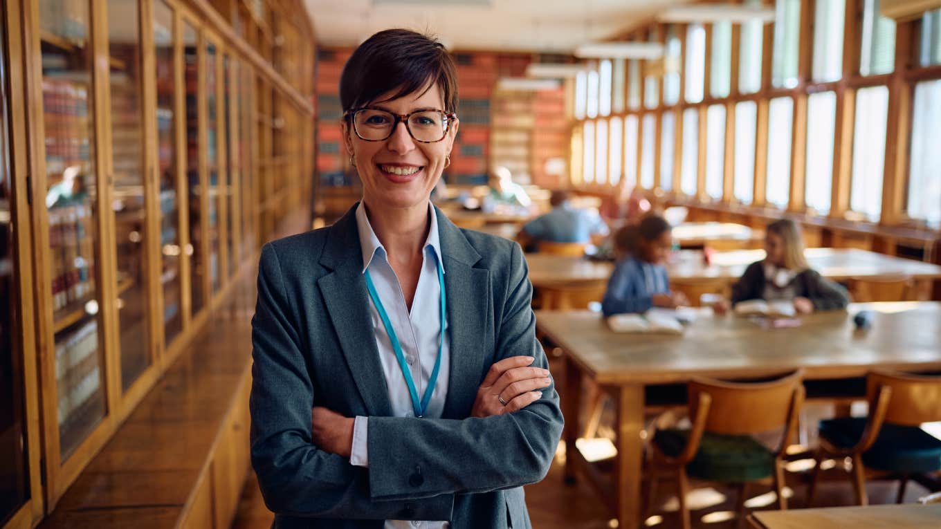 Portrait of happy female professor during a class at high school looking at camera