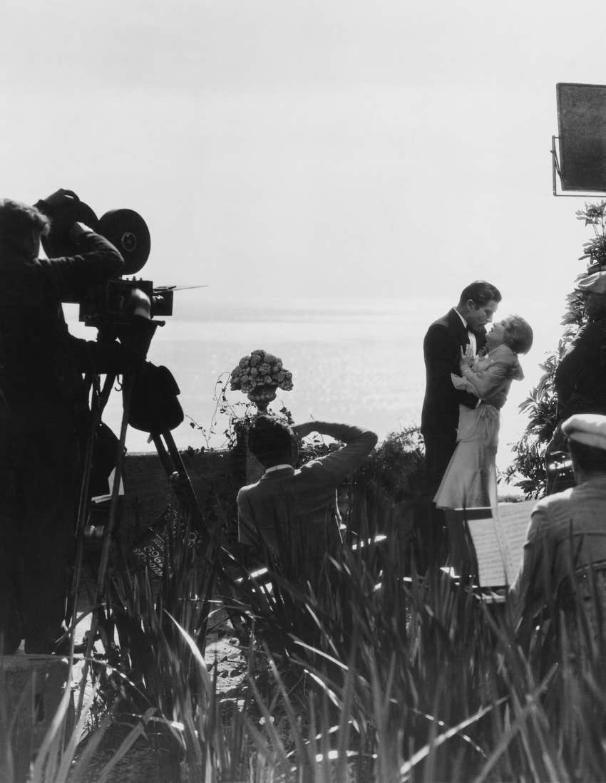 Couple, standing, filming, movie