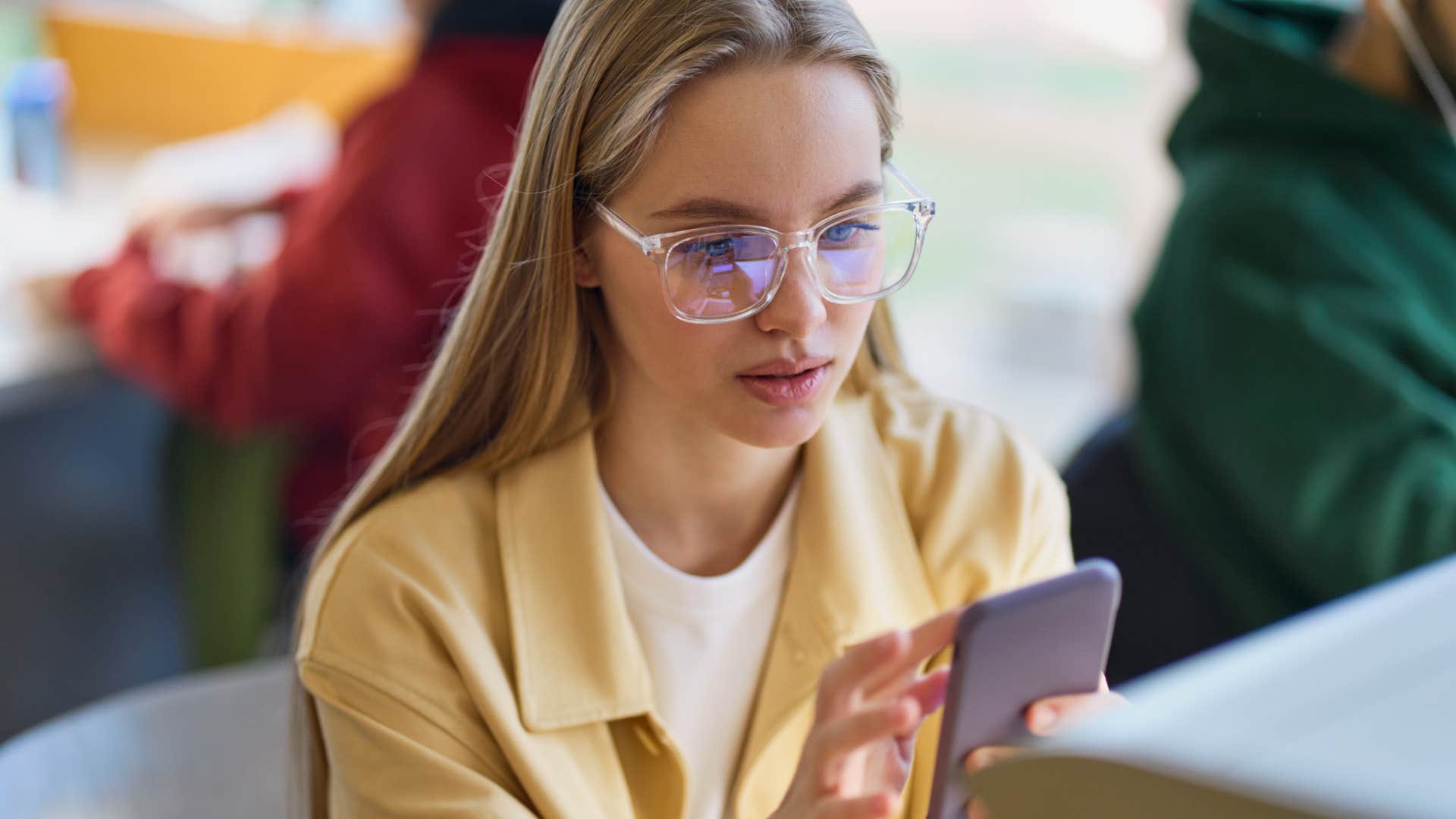 Serious Gen Z woman scrolling on her phone