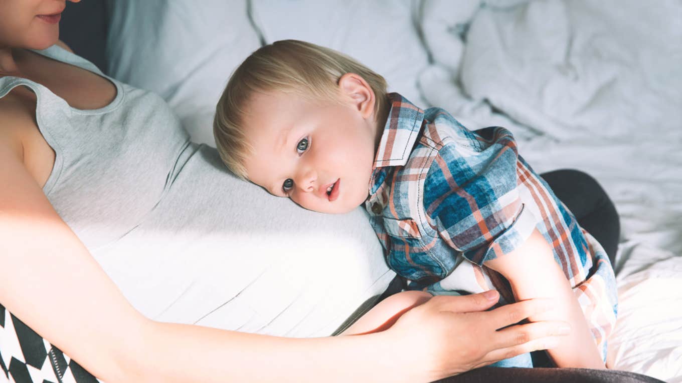 toddler resting on mom's pregnant belly 