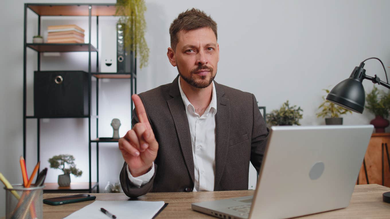 businessman sitting at desk saying no