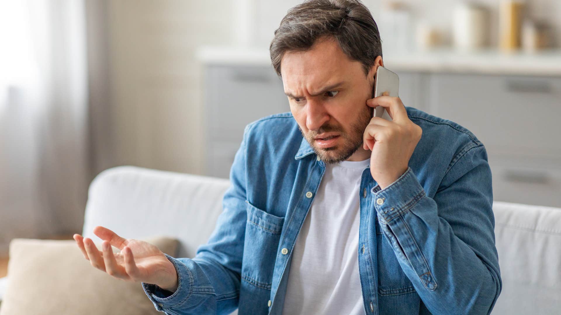 Man arguing with someone on the phone.