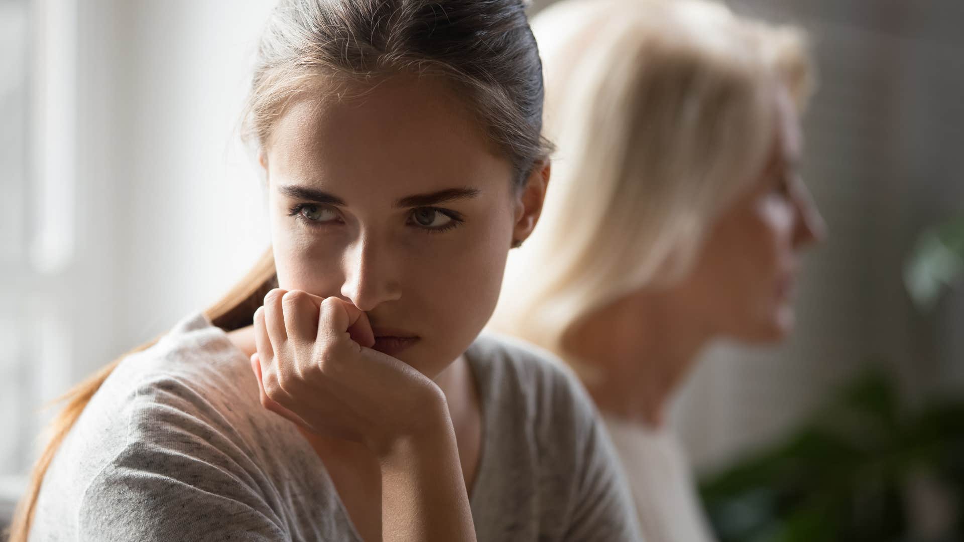 Adult woman turned away from her mother