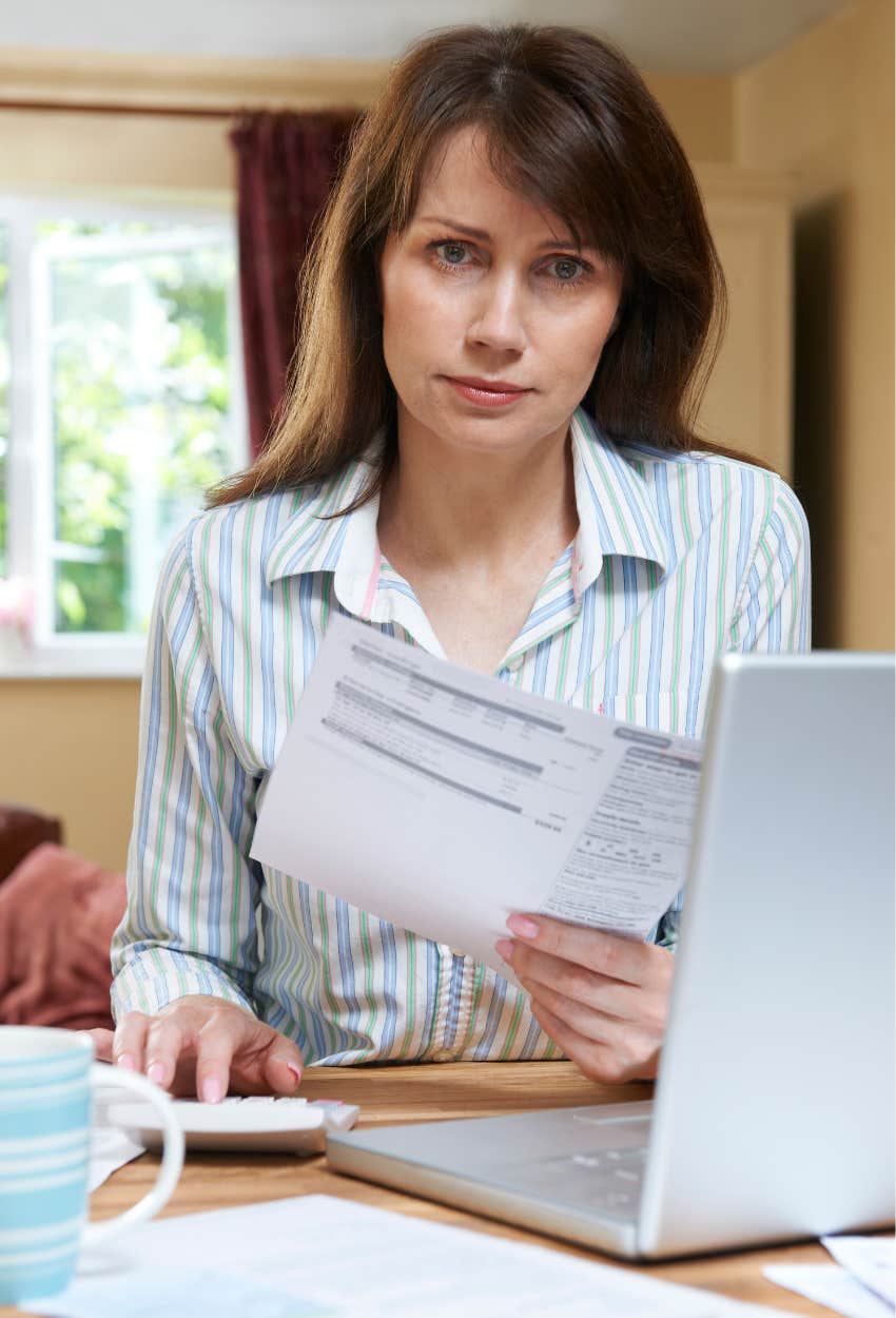 woman reviewing bank statements showing money savings account