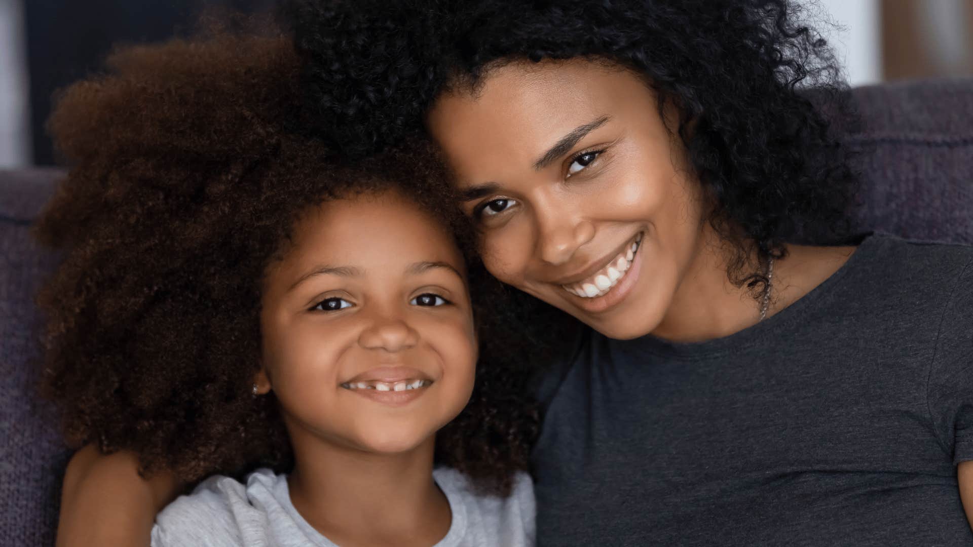 Nonjudgmental mother and daughter smile