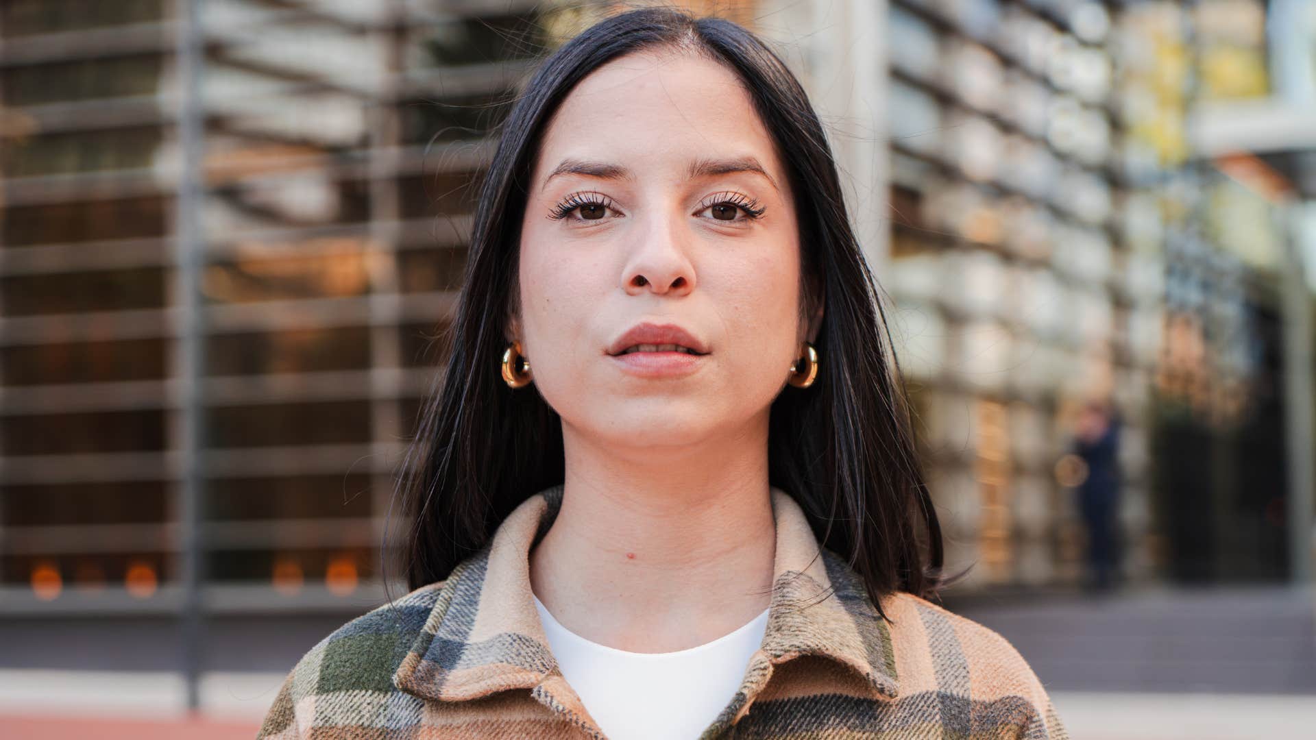 woman only looking at camera with serious expression.