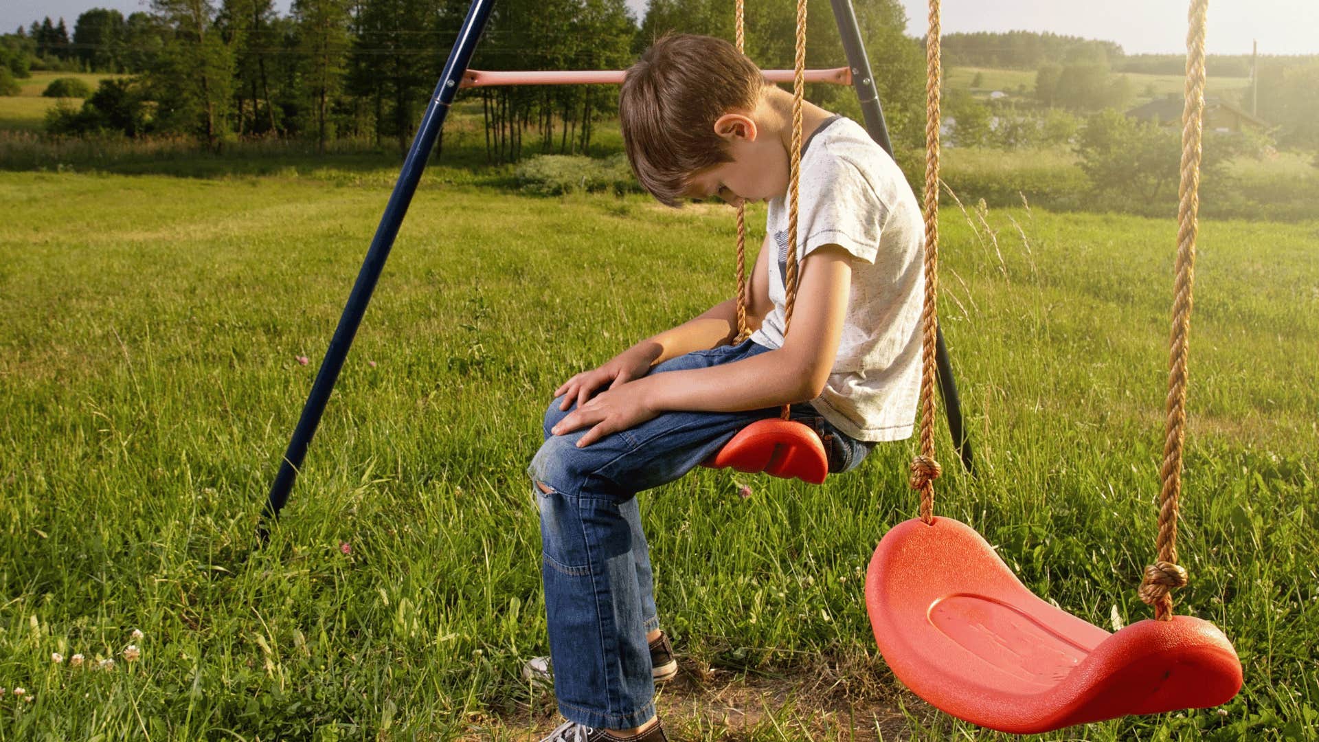 lonely kid on a swing