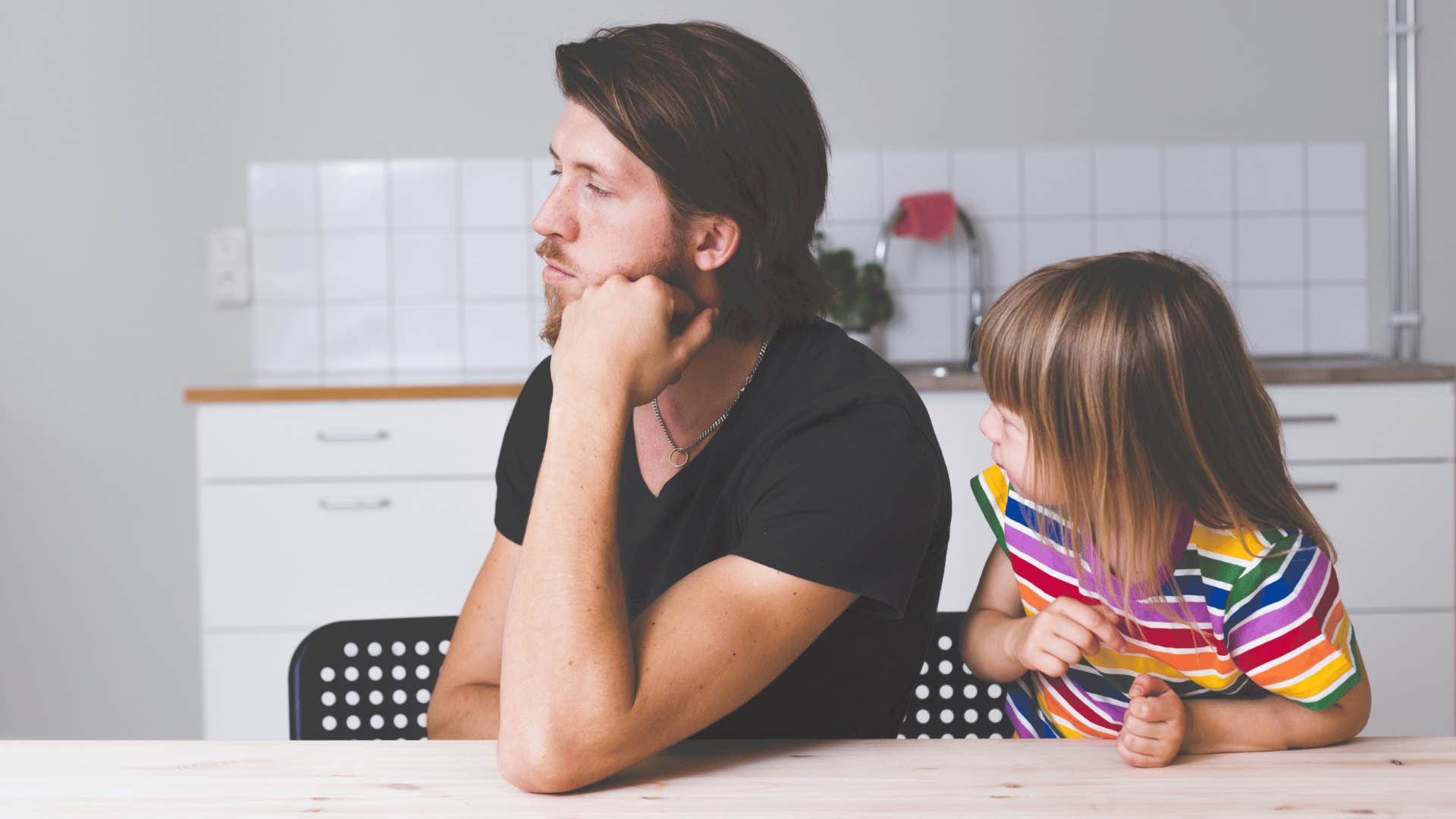 man ignoring little girl and dismissing her emotions