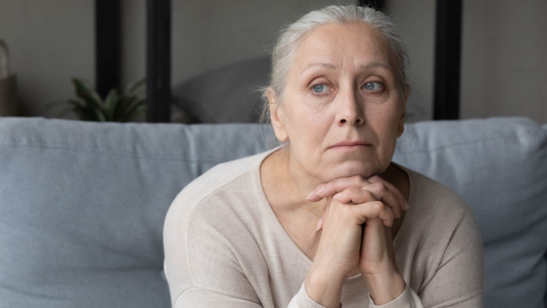 older, sad woman staring off into space