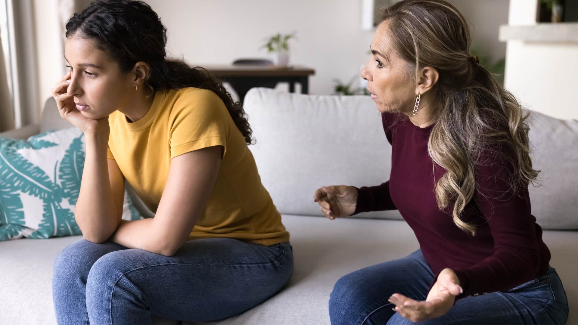 Mom arguing with her adult daughter on the couch.