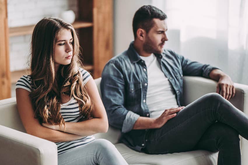 couple ignoring each other on couch