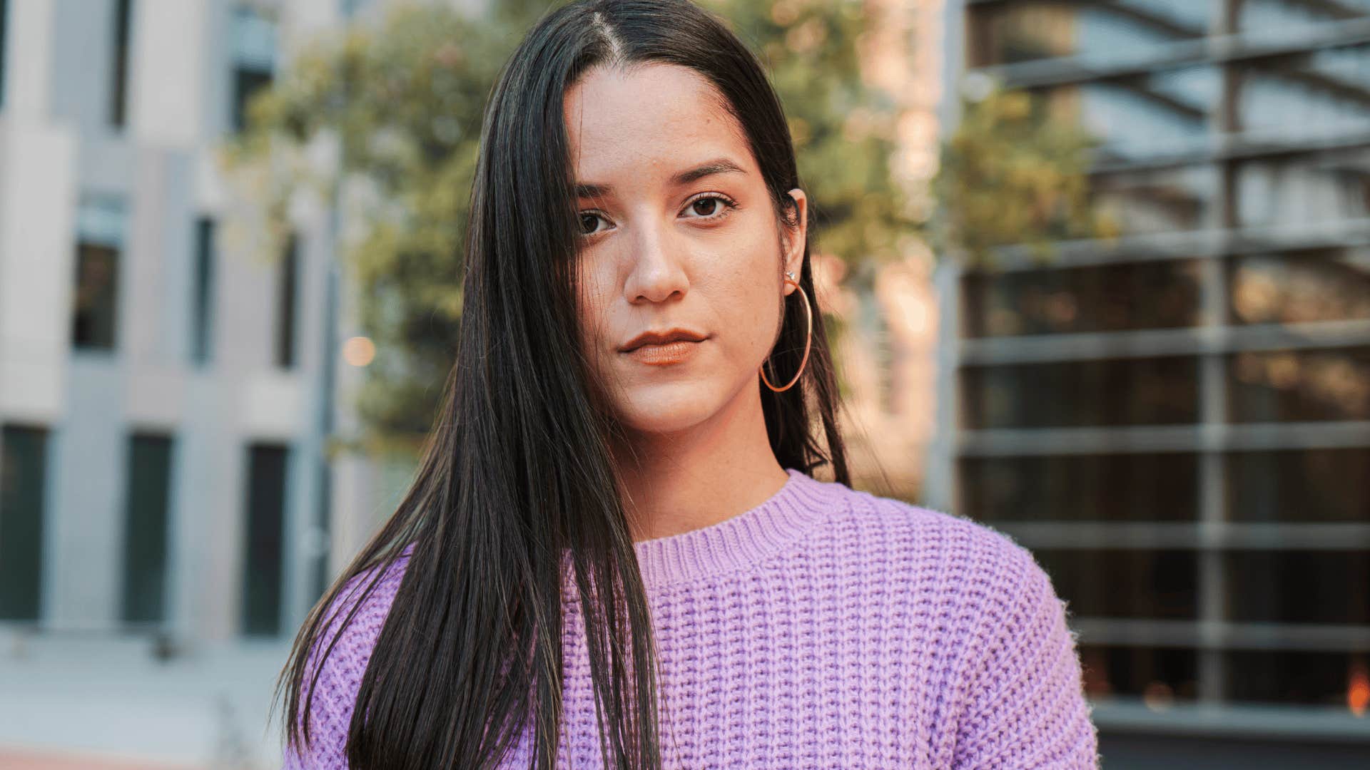 confident woman in purple sweater