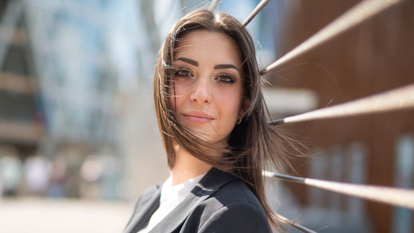 Portrait of a young woman near a bridge