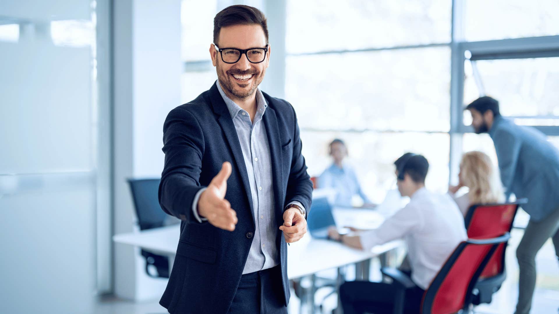 man reaching out to shake hand