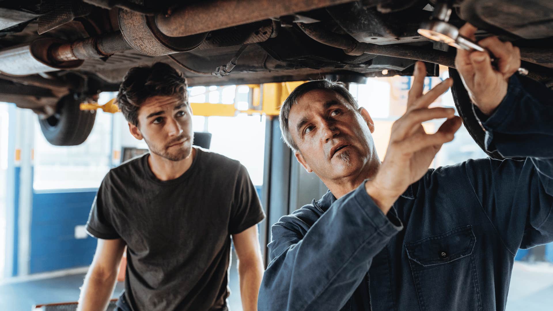 two men repairing car