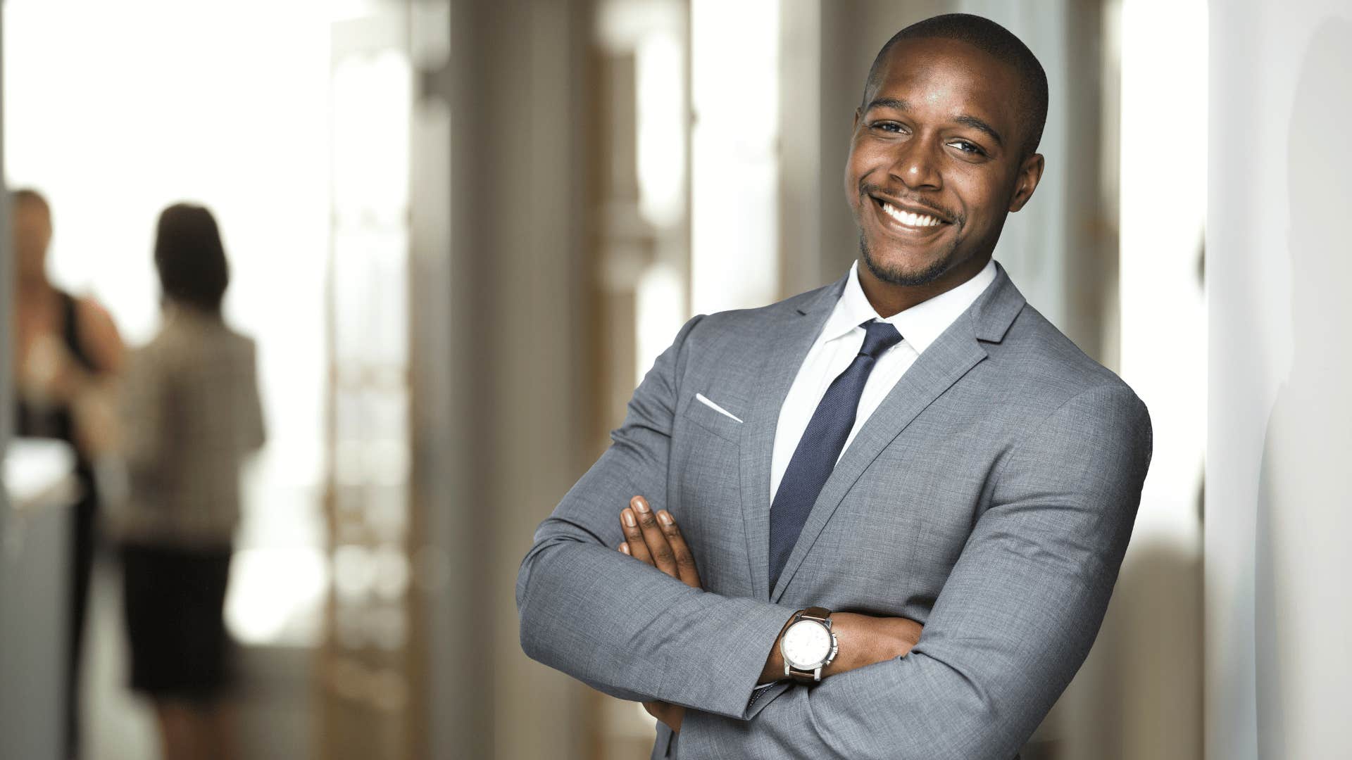 confident man crossing arms and smiling