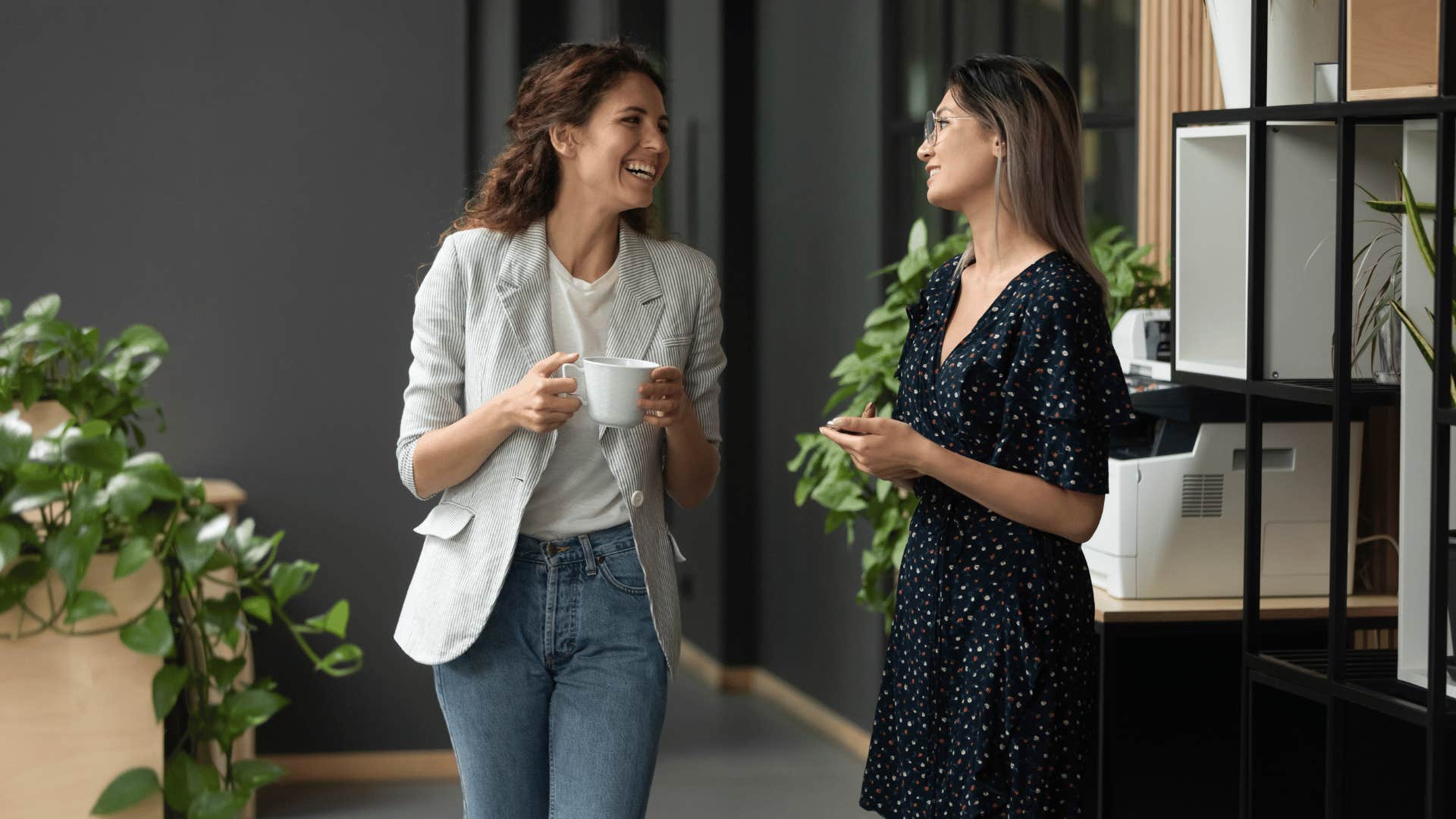 two coworkers talking and walking together 