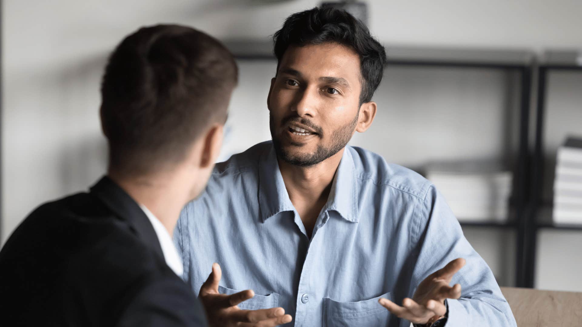 man explaining something to coworker