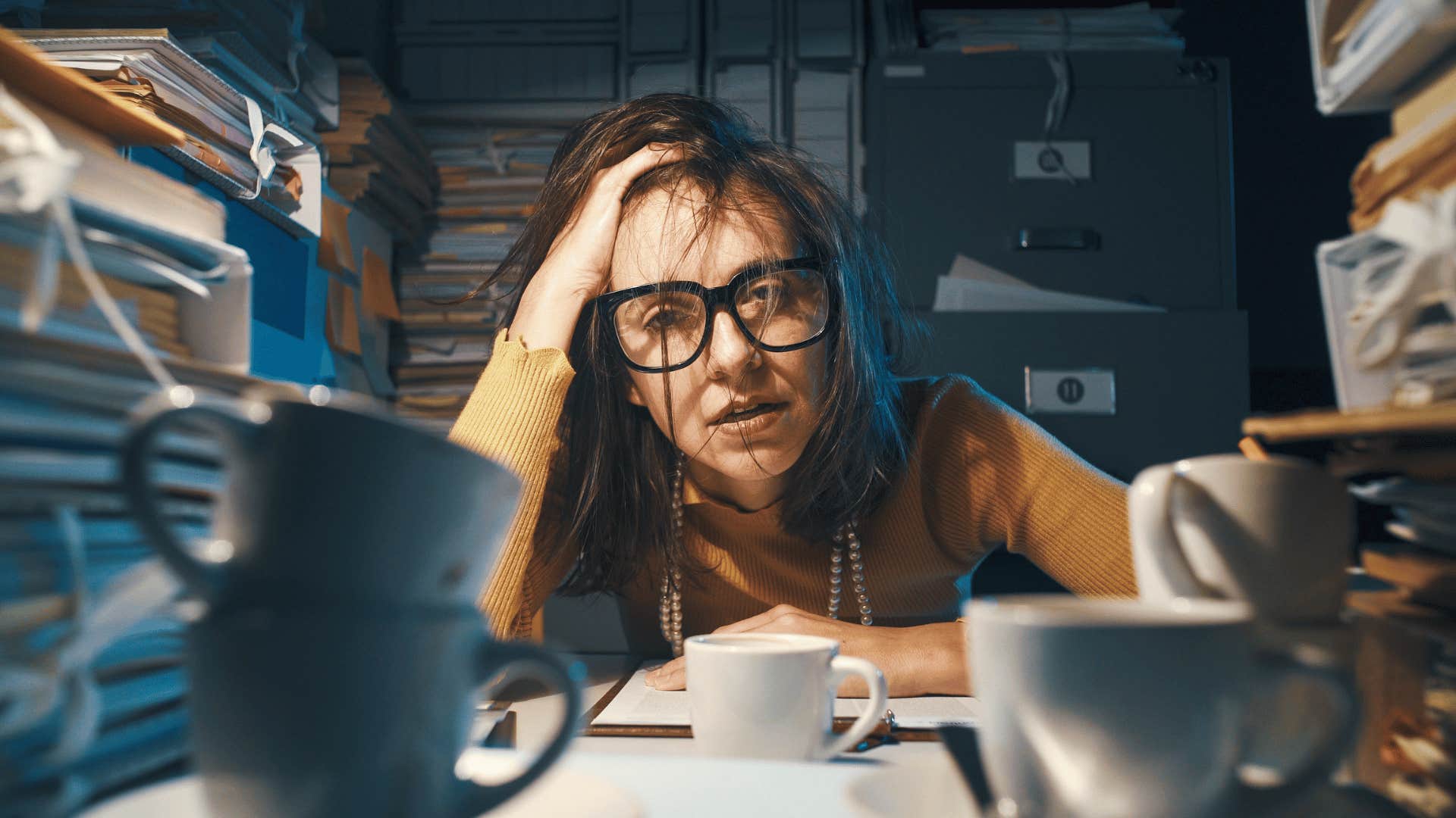 stressed woman with a messy desk