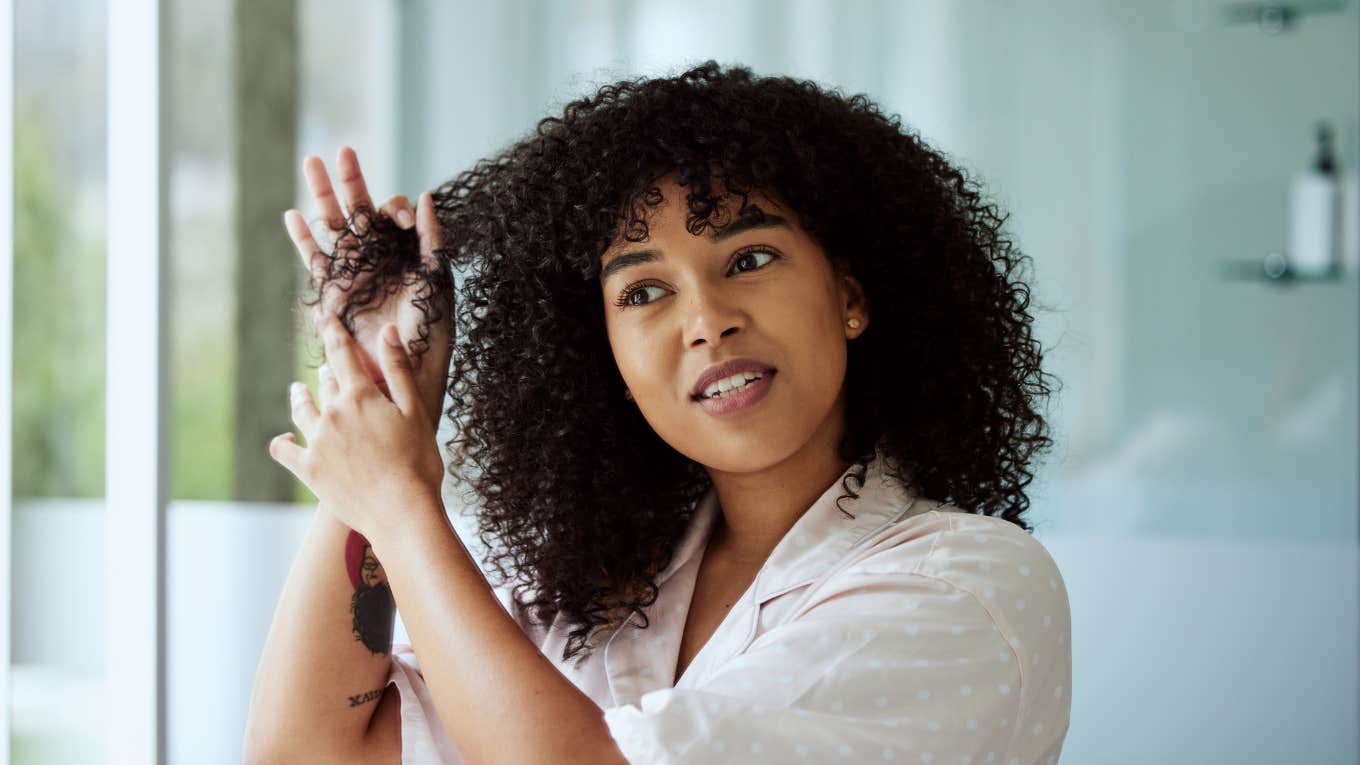 Beautiful woman styling natural hair