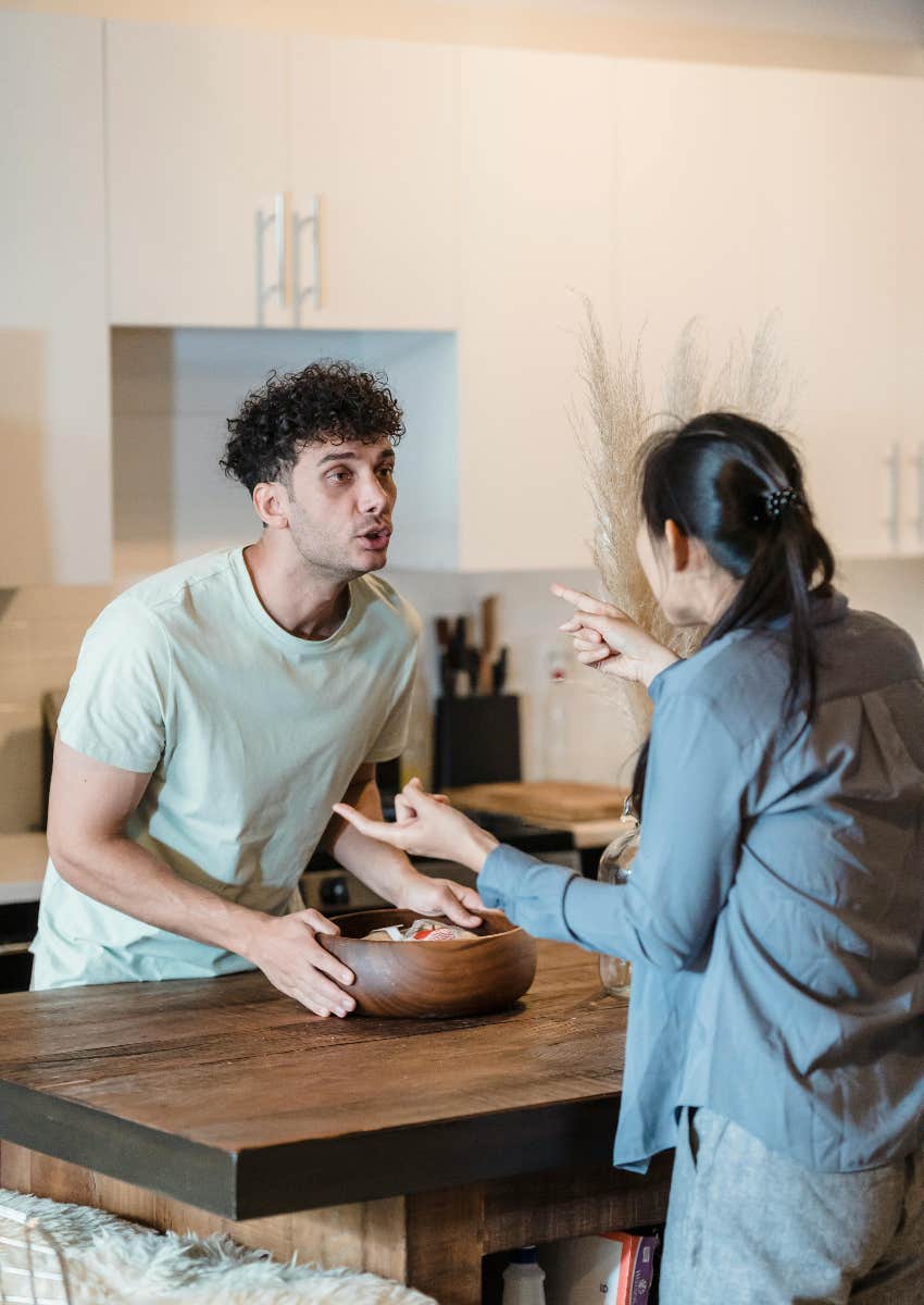 man and woman arguing over kitchen table